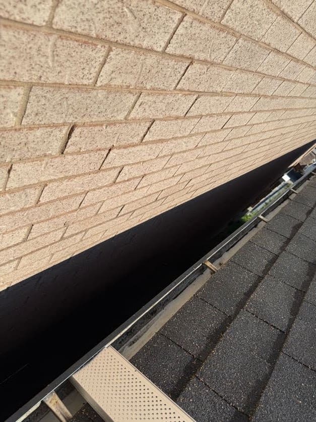 Perforated leaf guard installed where the shingles meet the fascia