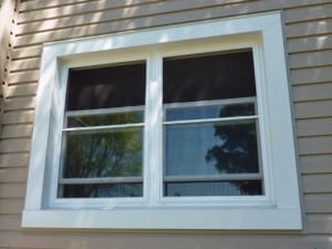 White aluminum window capping on a home with beige siding